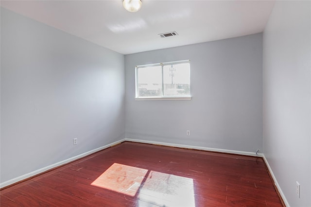 spare room featuring dark hardwood / wood-style flooring