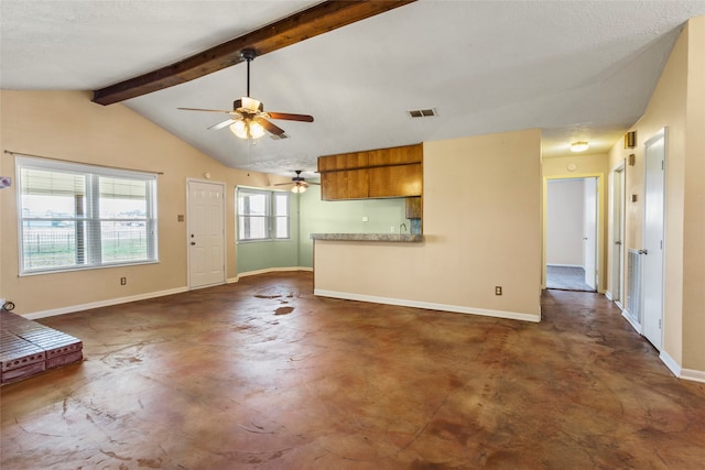 unfurnished living room featuring lofted ceiling with beams and ceiling fan