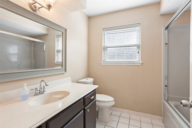 full bathroom featuring tile patterned floors, toilet, combined bath / shower with glass door, and vanity