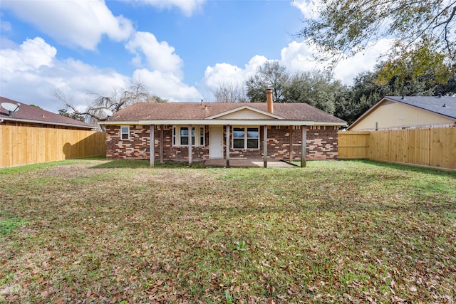 rear view of house with a yard and a patio area