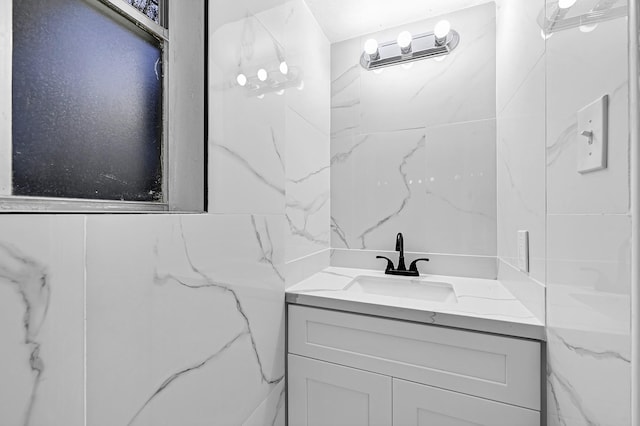 bathroom featuring vanity and tile walls