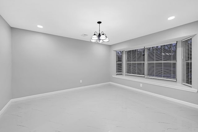 empty room with an inviting chandelier