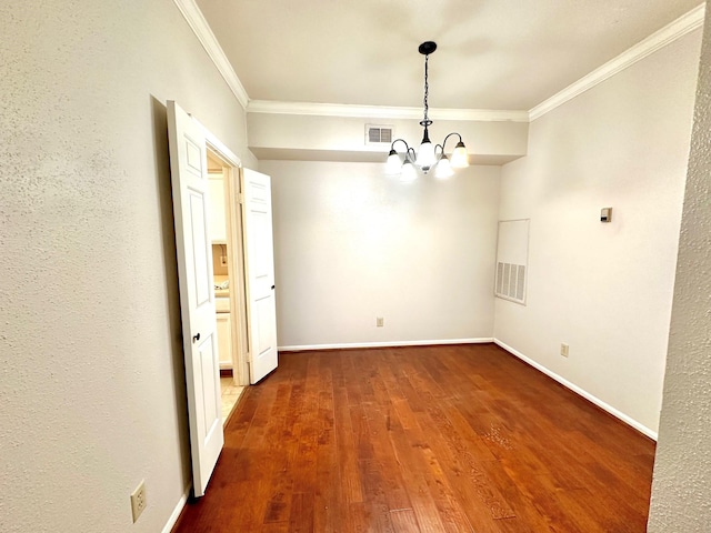 unfurnished dining area with an inviting chandelier, crown molding, and dark hardwood / wood-style floors