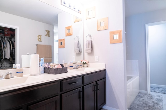 bathroom with a tub to relax in and vanity