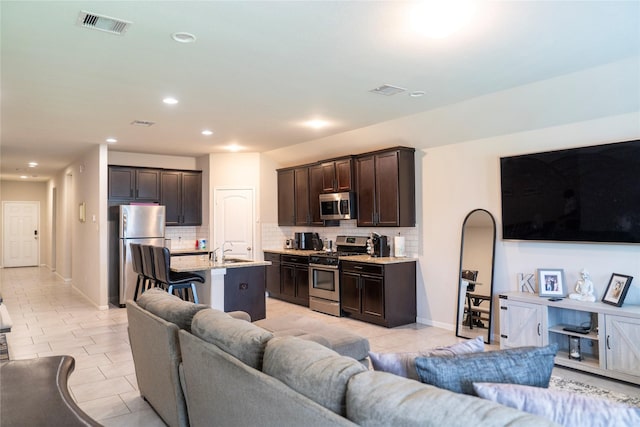 tiled living room featuring sink