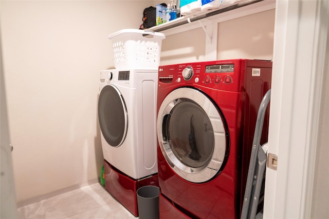 laundry room featuring washer and clothes dryer and light tile patterned floors