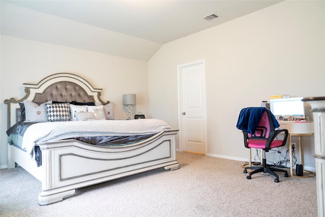 carpeted bedroom with vaulted ceiling