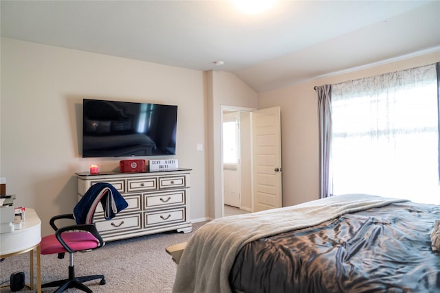 carpeted bedroom with multiple windows and vaulted ceiling