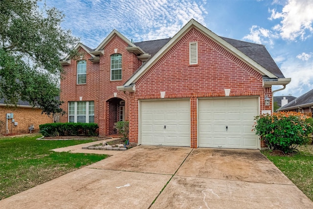 traditional home featuring a garage, driveway, a front yard, and brick siding