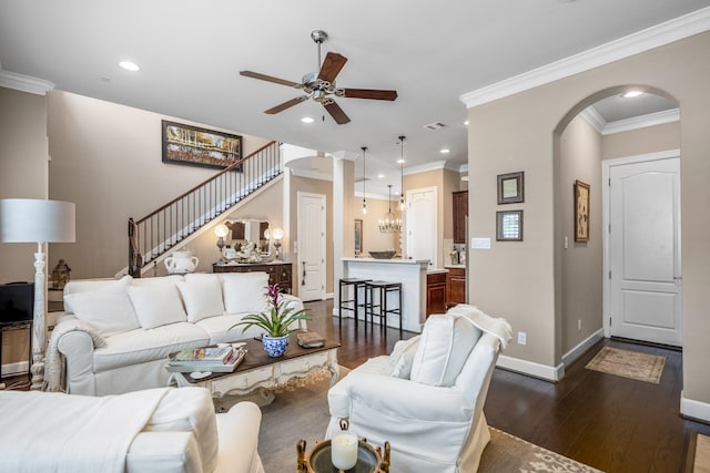 living room with crown molding, decorative columns, dark hardwood / wood-style floors, and ceiling fan