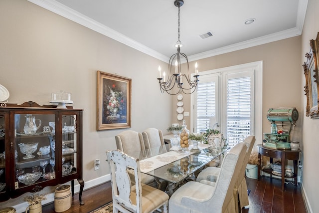 dining area featuring a notable chandelier, crown molding, and dark wood-type flooring