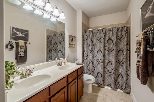 bathroom featuring tile patterned floors, vanity, and toilet