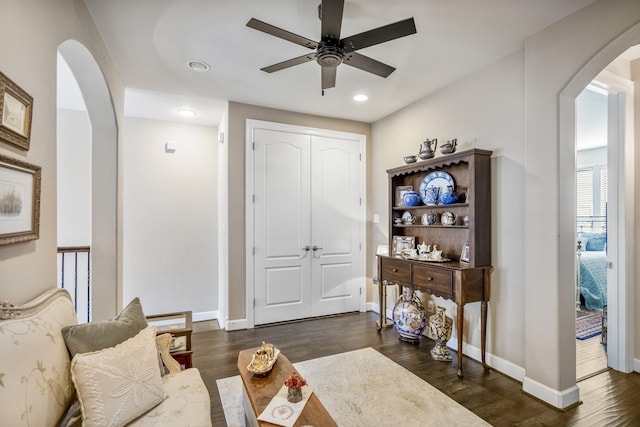 interior space with dark wood-type flooring and ceiling fan