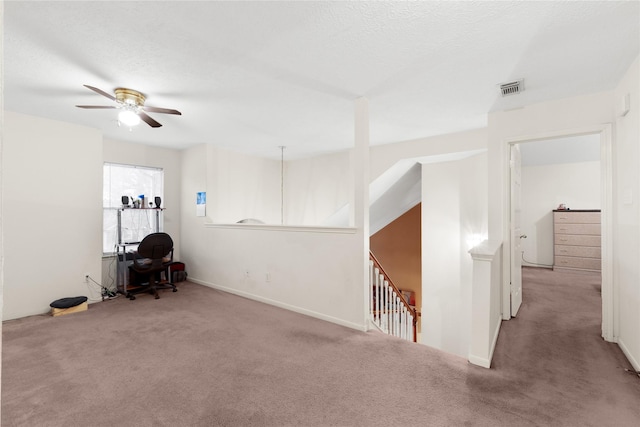 carpeted spare room with a textured ceiling