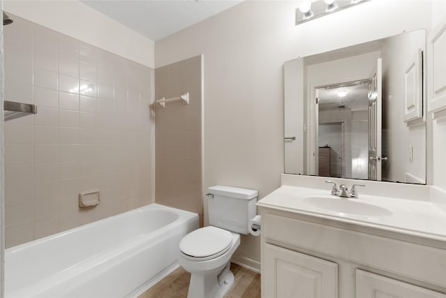 full bathroom with vanity, toilet, and tiled shower / bath