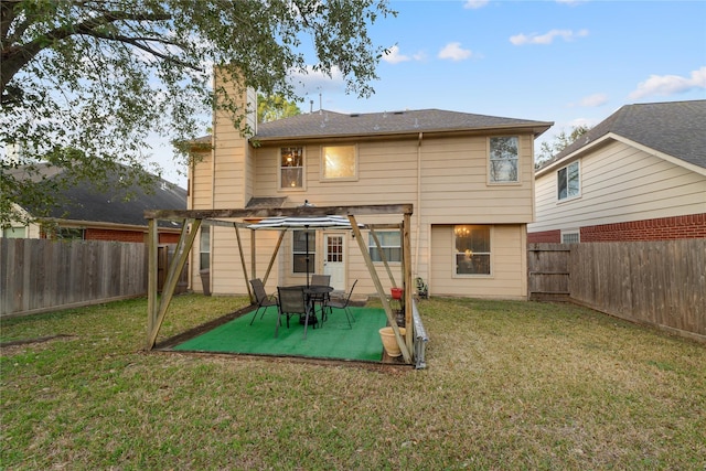 rear view of house with a yard, a pergola, and a patio