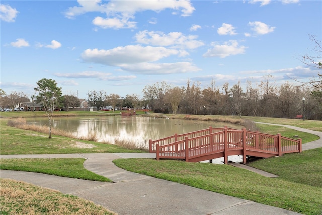 dock area featuring a water view and a lawn