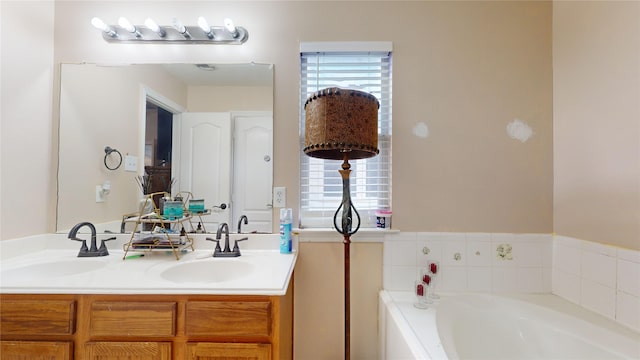 bathroom with vanity, a wealth of natural light, and a tub