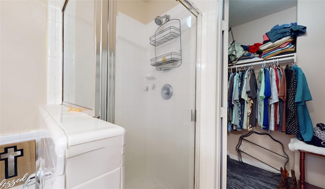 bathroom with washer / dryer and walk in shower