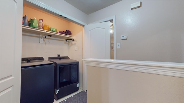 clothes washing area featuring washer and dryer