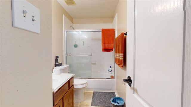 full bathroom with vanity, combined bath / shower with glass door, tile patterned floors, and toilet