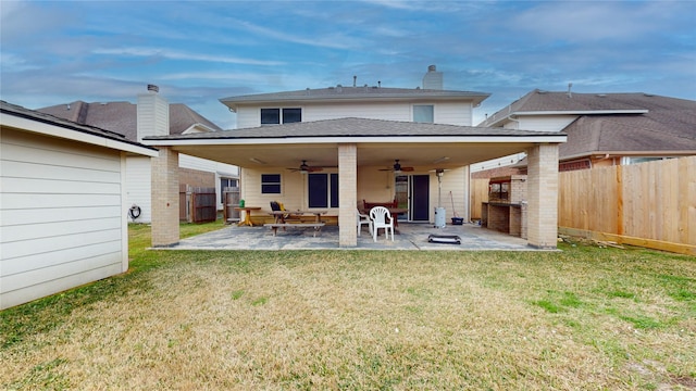 back of property featuring a patio area, ceiling fan, and a lawn