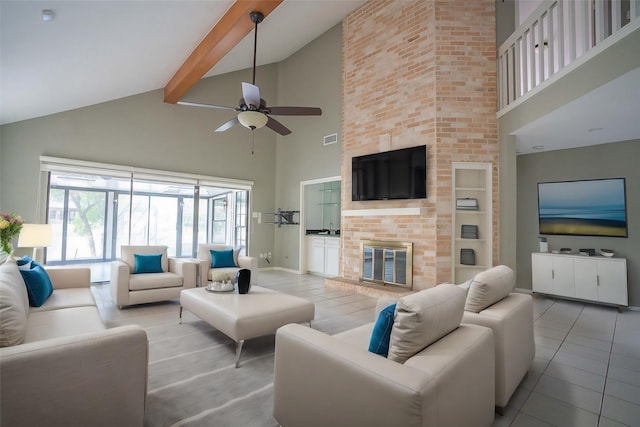 living room featuring high vaulted ceiling, a fireplace, beamed ceiling, light tile patterned floors, and ceiling fan