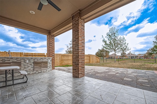 view of patio / terrace with exterior kitchen and ceiling fan