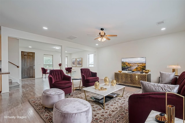 living room with recessed lighting, ceiling fan, stairway, and wood finished floors