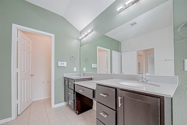 3215 Laurel Bend Ln, Pearland, TX 77584 - full bathroom featuring tile patterned floors, double vanity, baseboards, and vaulted ceiling