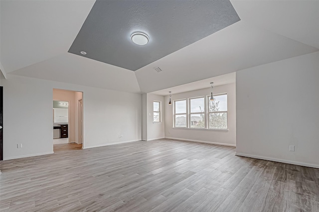 3215 Laurel Bend Ln, Pearland, TX 77584 - spare room featuring lofted ceiling, light wood-style flooring, and baseboards