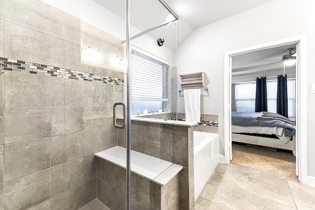 full bathroom with ensuite bath, lofted ceiling, ceiling fan, a shower stall, and a garden tub