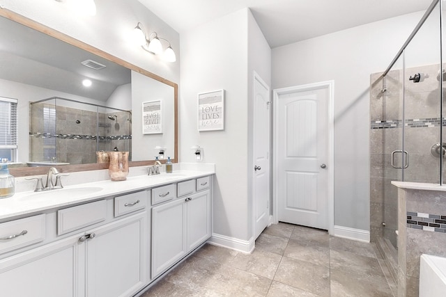 bathroom featuring a sink, baseboards, a stall shower, and double vanity