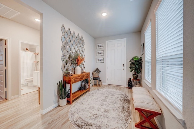 entrance foyer with plenty of natural light and light hardwood / wood-style flooring