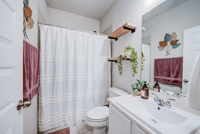 bathroom featuring vanity, toilet, and tile patterned flooring