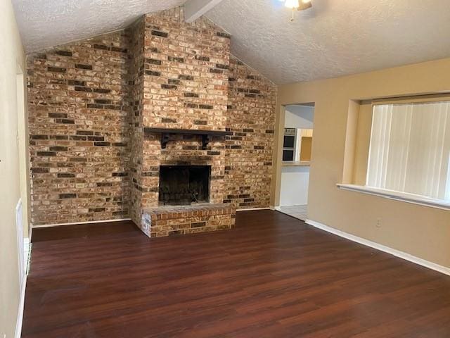 unfurnished living room with vaulted ceiling with beams, dark hardwood / wood-style floors, and a brick fireplace