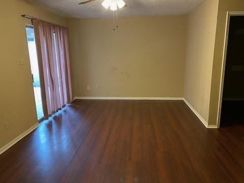 unfurnished room with ceiling fan, a textured ceiling, and dark hardwood / wood-style flooring