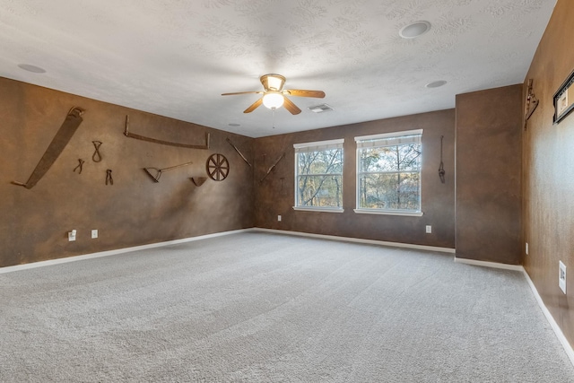 unfurnished room featuring a textured ceiling, light colored carpet, and ceiling fan