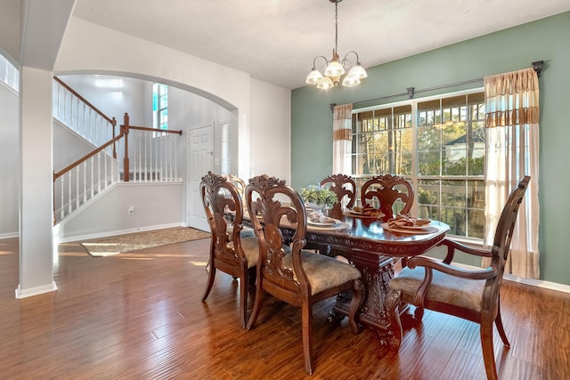 dining space featuring an inviting chandelier and dark hardwood / wood-style flooring