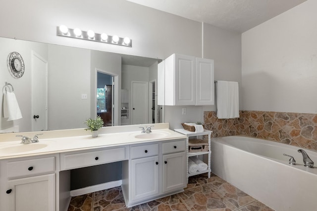 bathroom featuring vanity and a bathtub