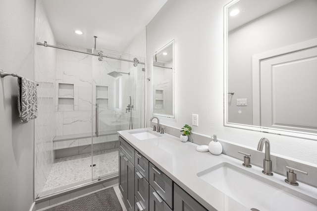 bathroom featuring vanity and a shower with door