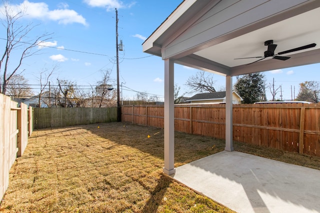 view of yard with a patio area and ceiling fan