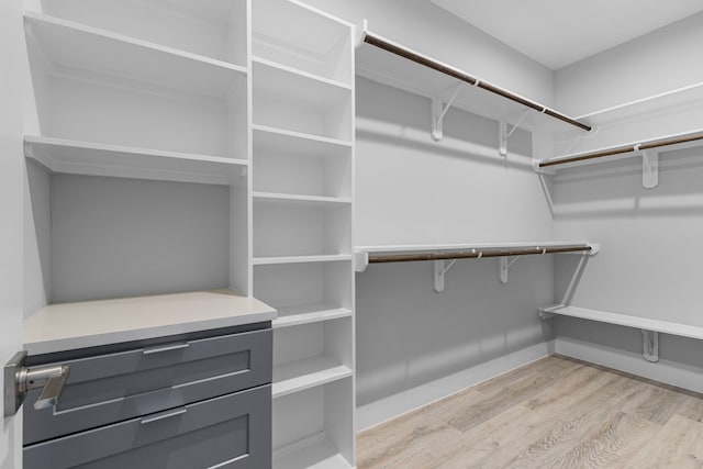 walk in closet featuring light hardwood / wood-style flooring