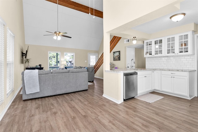 kitchen with beam ceiling, dishwasher, light wood-type flooring, and white cabinets