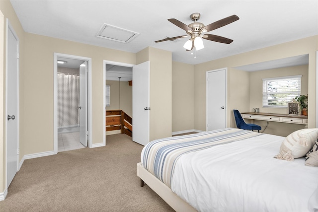 carpeted bedroom featuring ensuite bath and ceiling fan