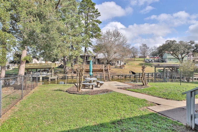 exterior space featuring a playground and a water view