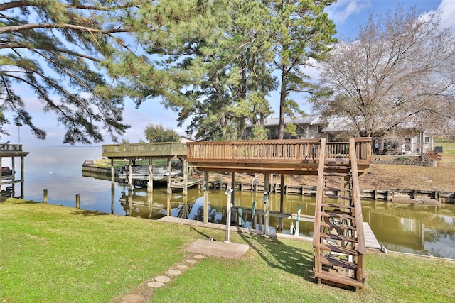 view of dock with a water view and a yard