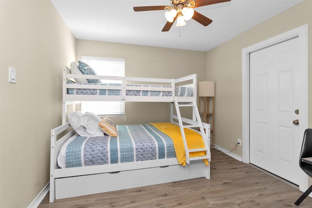 bedroom featuring hardwood / wood-style floors and ceiling fan