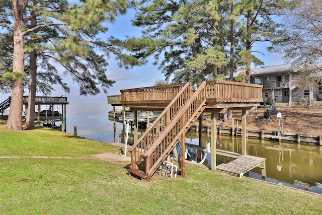 view of dock with a water view and a yard