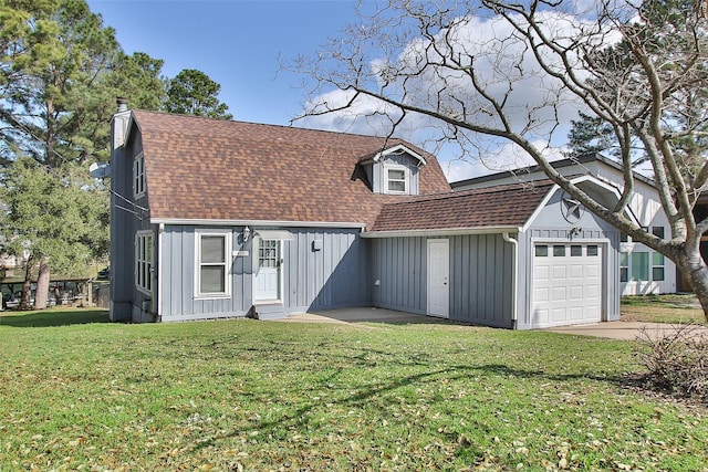 view of front of house with a garage and a front lawn